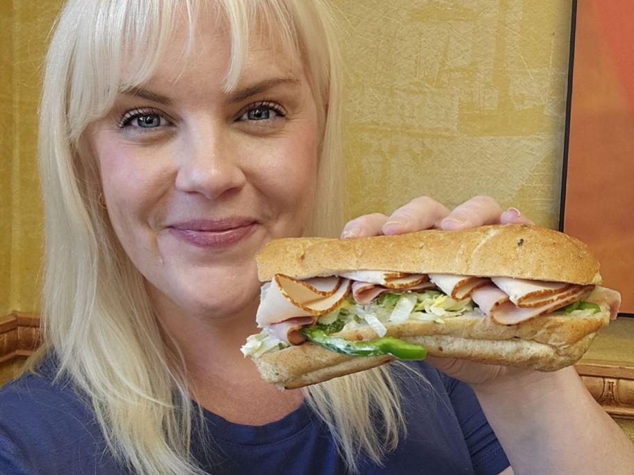 Woman holding a 6" Subway Sandwich