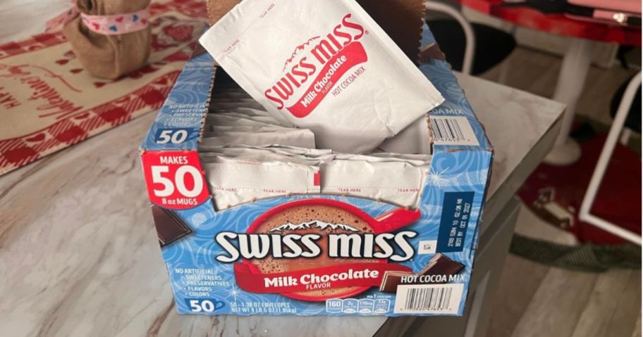 Swiss Miss Milk Chocolate Flavor Hot Cocoa Mix 1.38oz 50-Count Box open on table