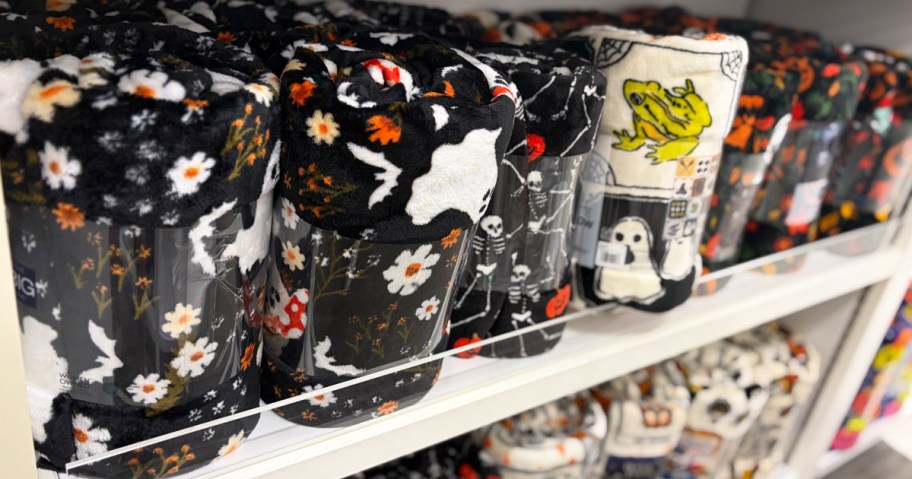 ghost and skeleton print blankets on a shelf