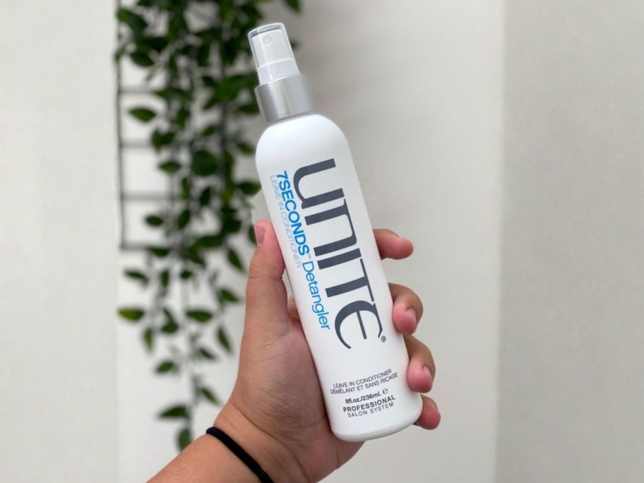 UNITE Hair 7SECONDS Detangler Leave-In Conditioner 8oz Spray bottle in hand