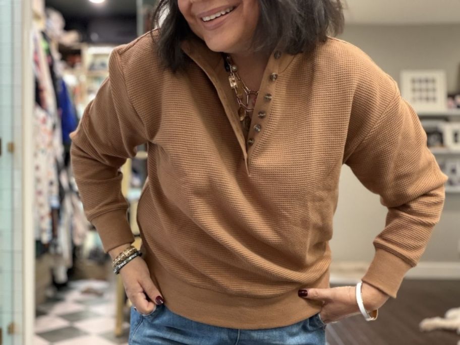 Woman wearing Waffle sweaters brown in her living room