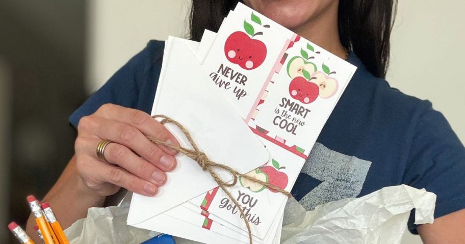 Woman holding a set of Walgreens Classroom Cards
