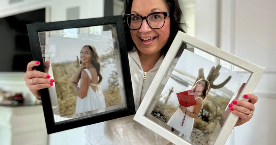 woman holding up 2 Walgreens floating frames