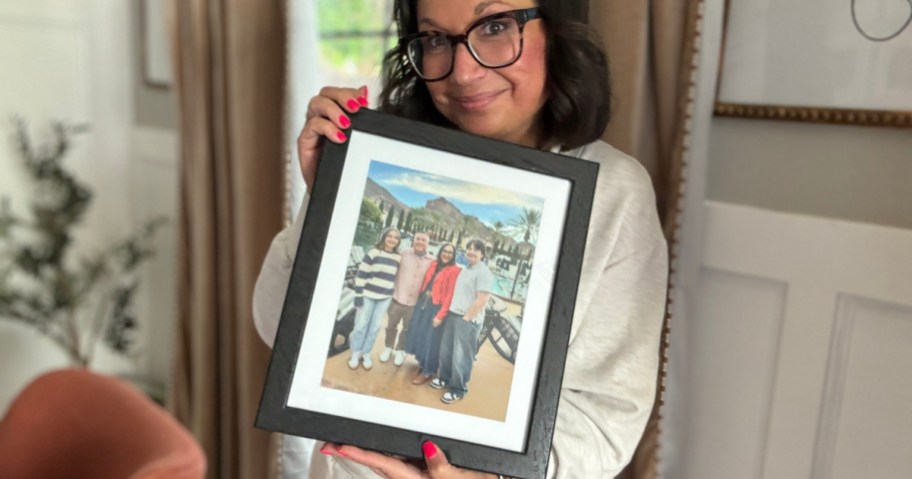 Woman holding up a Walgreens matted photo print photo