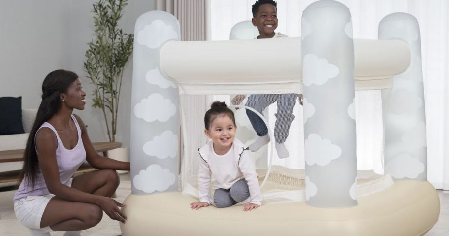 Mom and two kids playing with a Bestway Bounce House