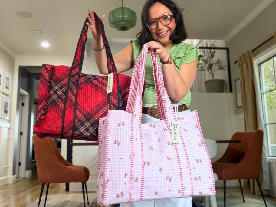 woman holding two different no boundaries cute tote bags