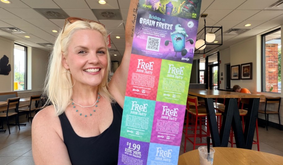 Woman holding open Wendy's boo book.