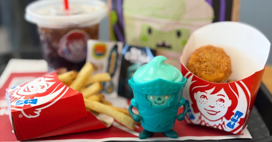 A Wendy's Kids Meal featuring chicken nuggets, fries, a drink, and a Frosty Frights toy in armor.