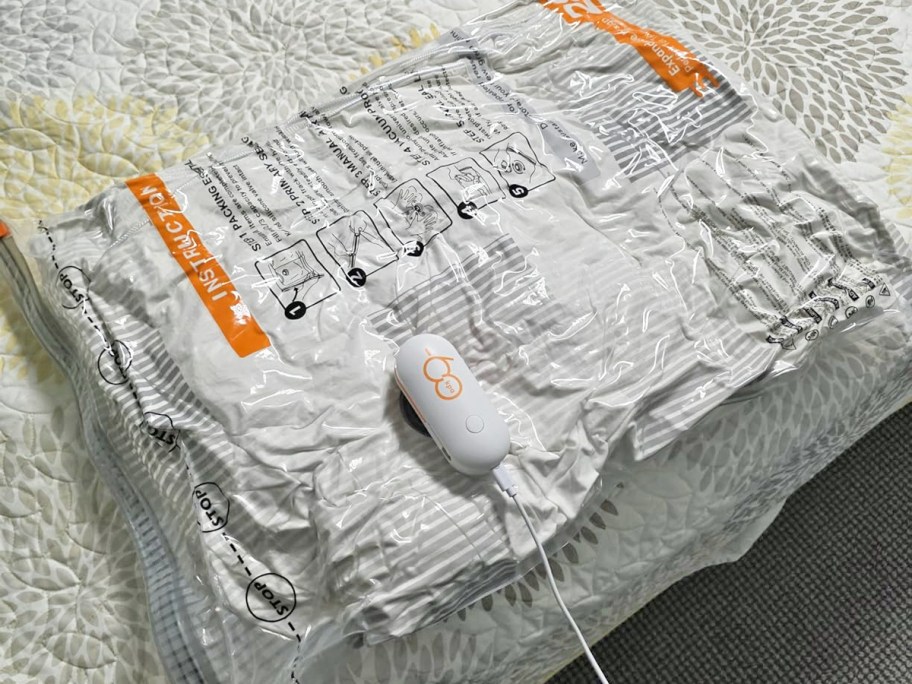 vacuum storage bag with pump sucking out the air