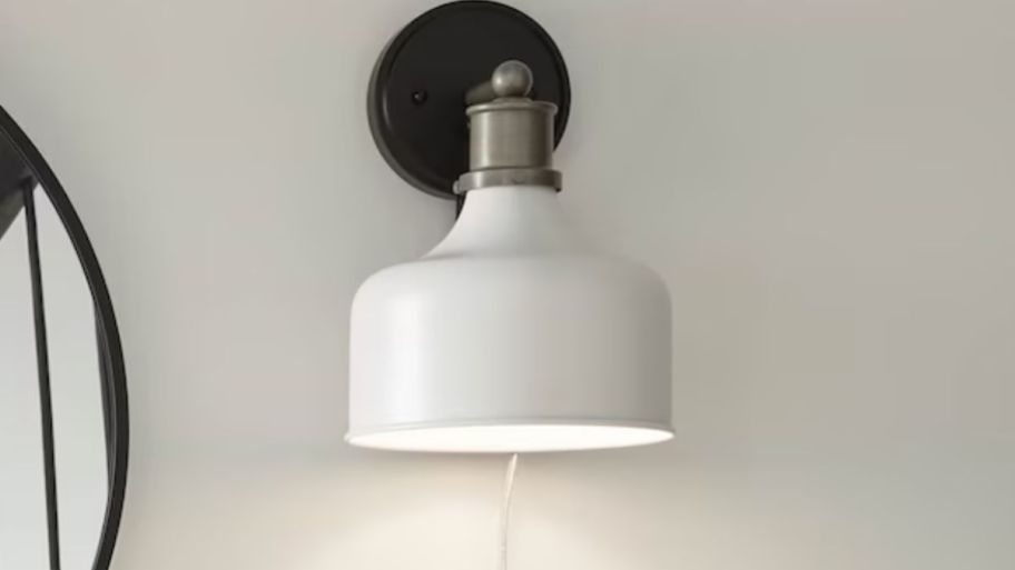 White wall scone displayed on a gray wall