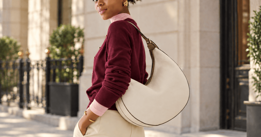Woman posing with Kate Spade bag on a street