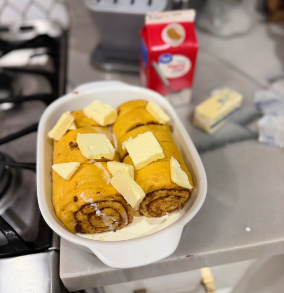 adding cream and butter to store-bought cinnamon rolls