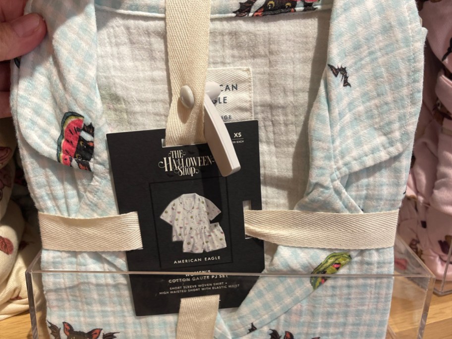 hand holding green and plaid halloween snoopy pjs