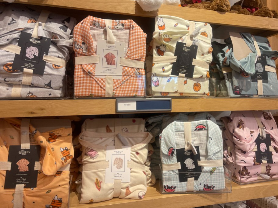 orange, pink, and blue halloween pajamas on shelf