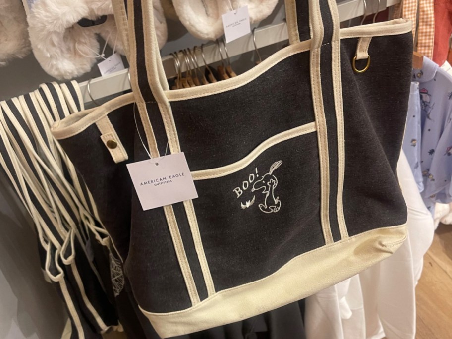 black snoopy tote hanging in store