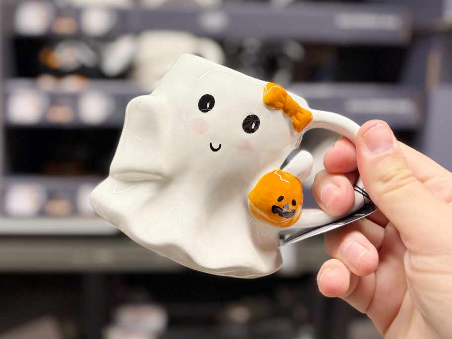 hand holding ghost mug 