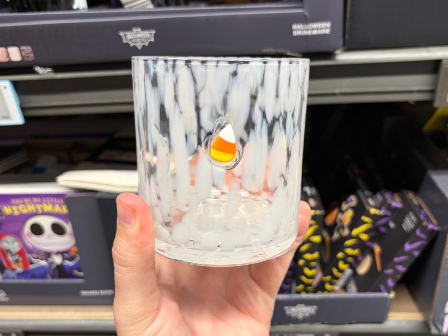 hand holding white candy corn glass 