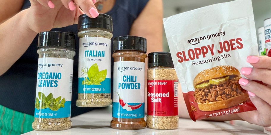 woman picking up amazon seasonings off countertop 
