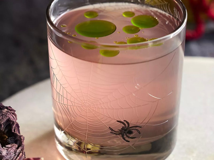 spider glass with pink drink inside