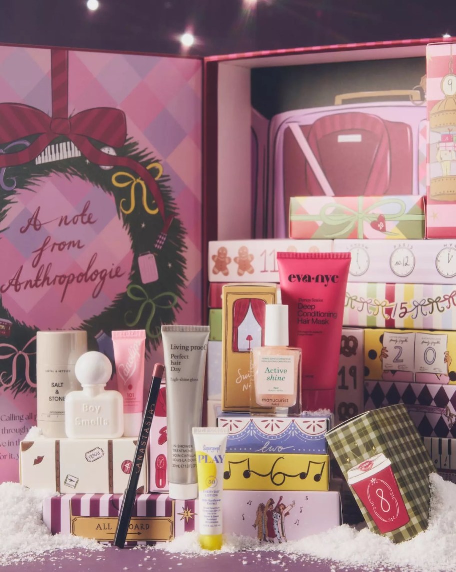 anthropologie beauty advent calendar with stack of beauty products on fake snow