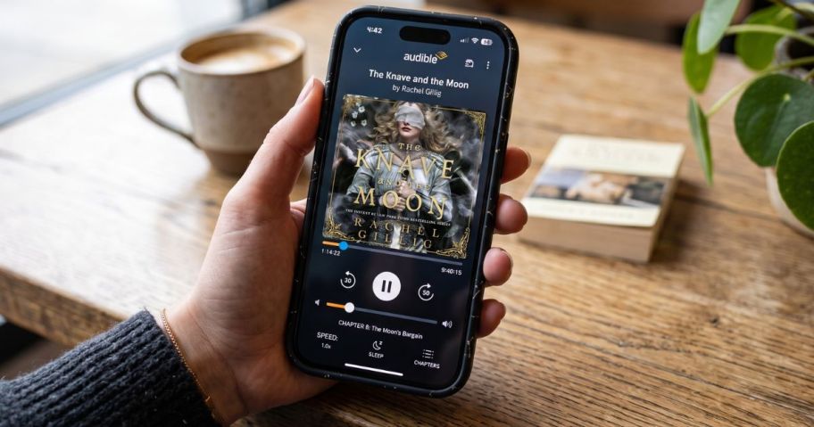 hand holding smartphone with audible app on it