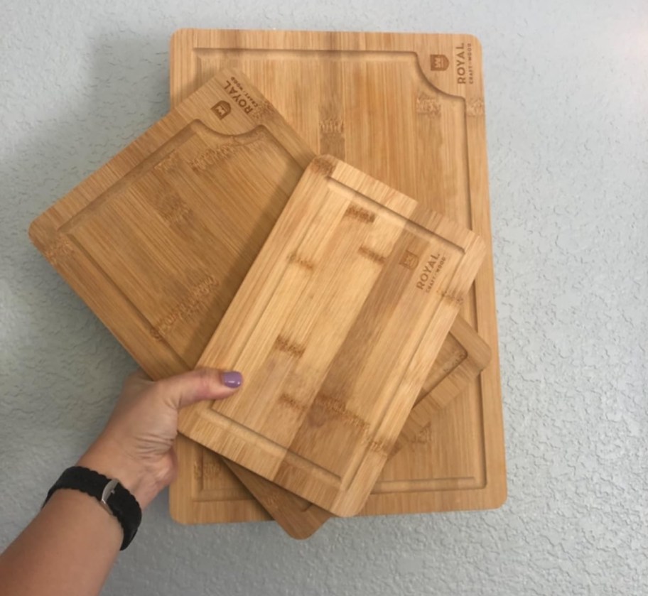 hand holding bamboo cutting boards
