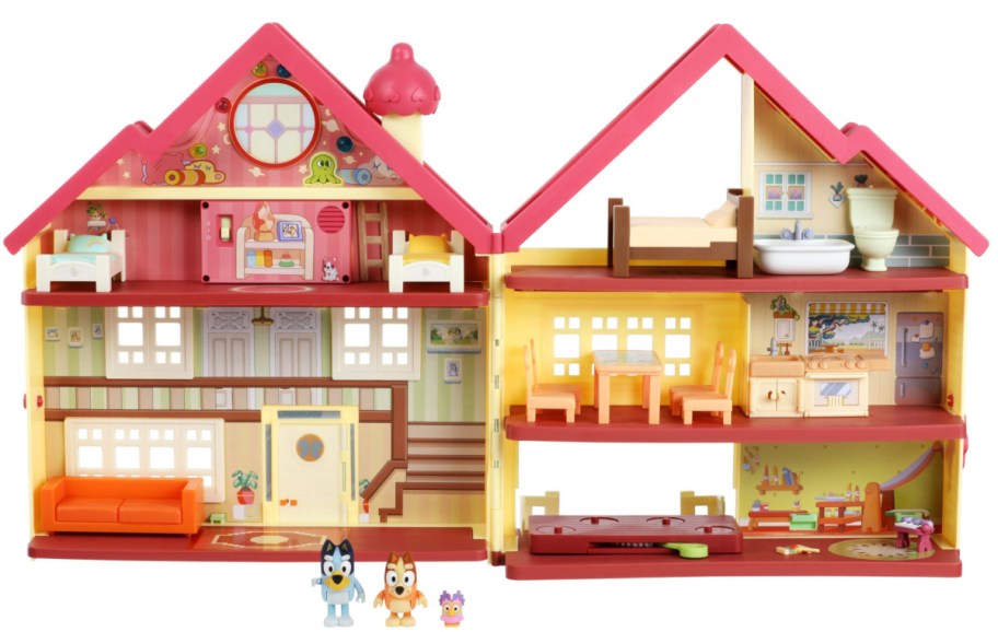 opened yellow toy house with red rook and two dog figures