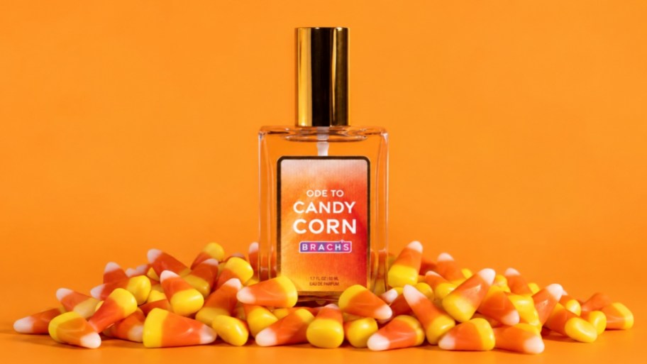 a bottle of candy corn perfume on a pile of candy corn