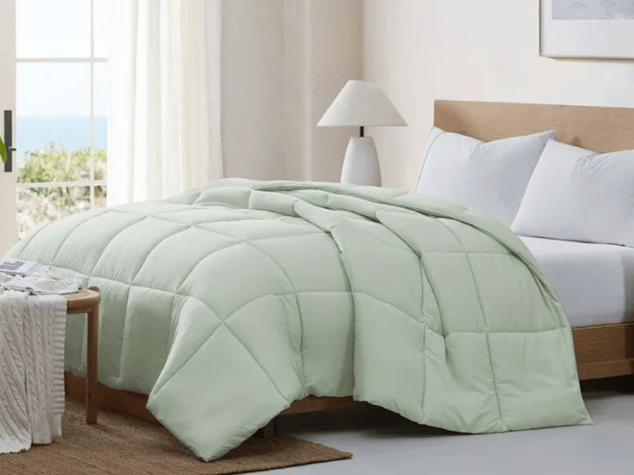 light green bedding on a bed