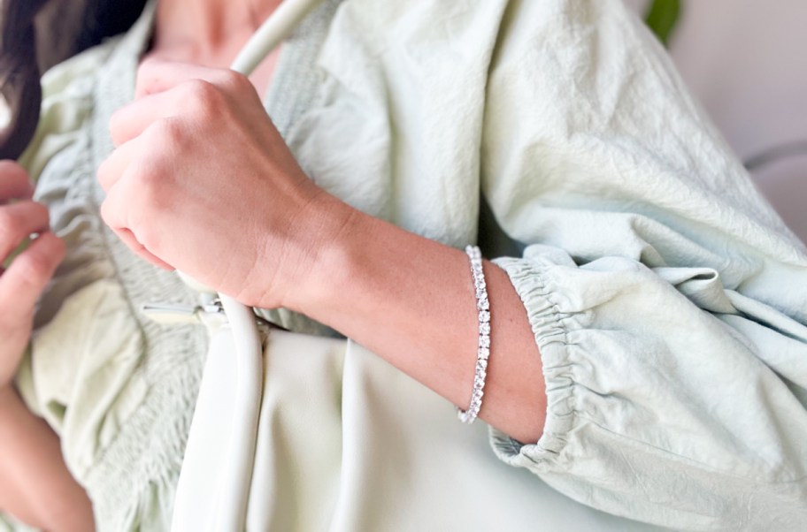 woman wearing a sparkly tennis bracelet