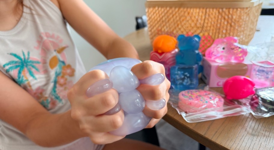 kid squeezing coconut oil ball squishy