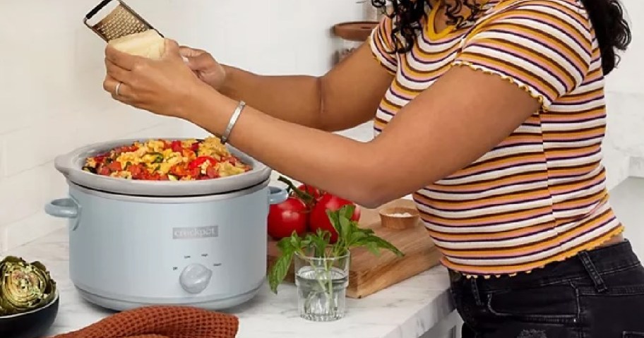 woman using a slow cooker in a kitchen