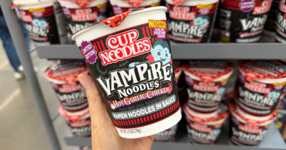 hand holding a cup of vampire cup of noodles in the store