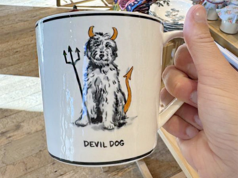 hand holding white dog mug