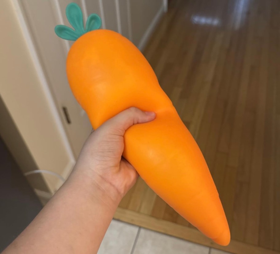 hand holding giant carrot squishy