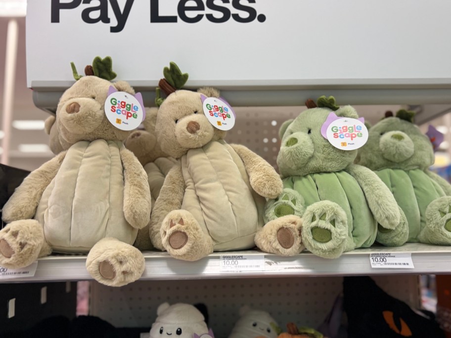 tan and green plush bears on store shelf