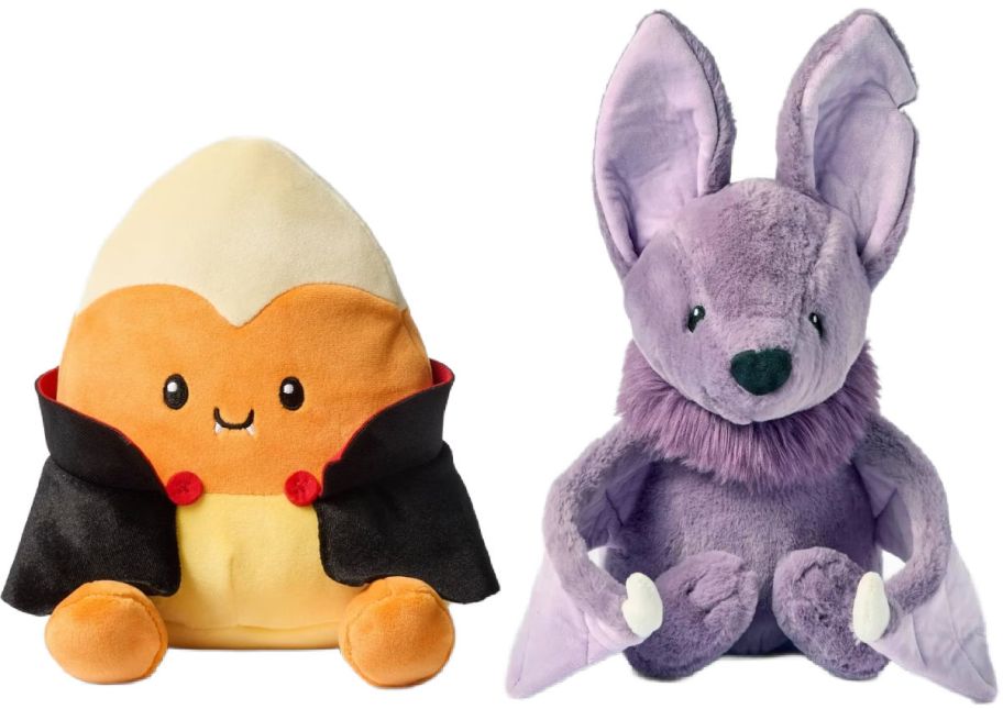 plush candy corn vampire next to plush purple bat
