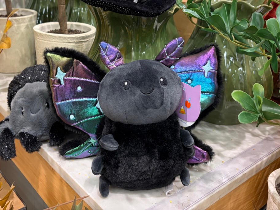 plush black moth with colorful wings