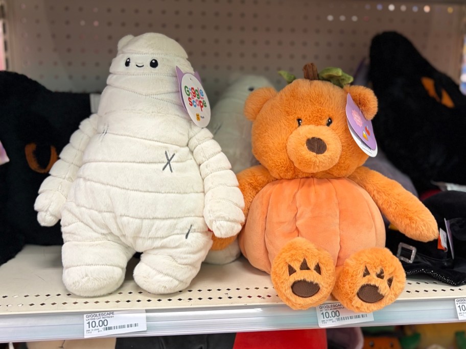 plush mummy and orange bear on shelf