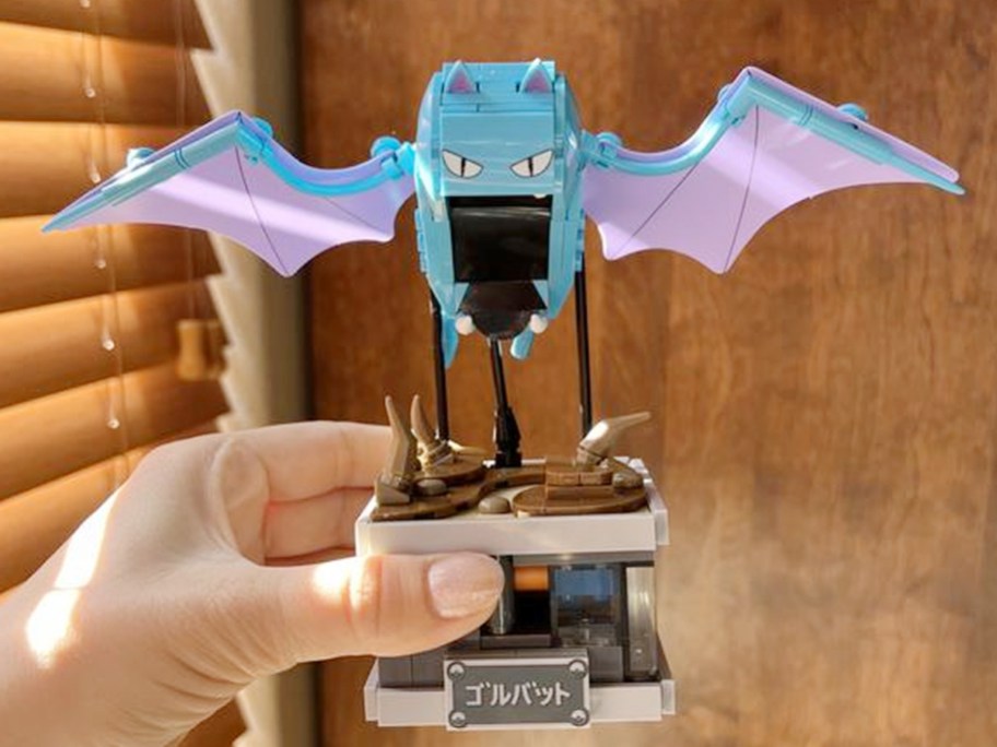 hand holding pokemon golbat