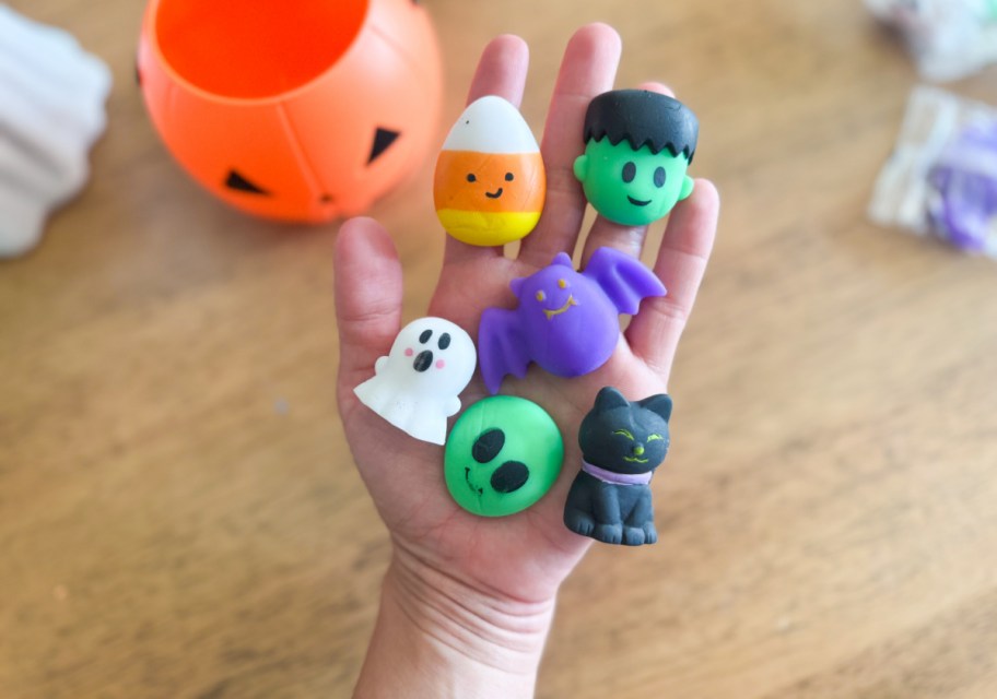 open hand with squishy toys in Halloween shapes