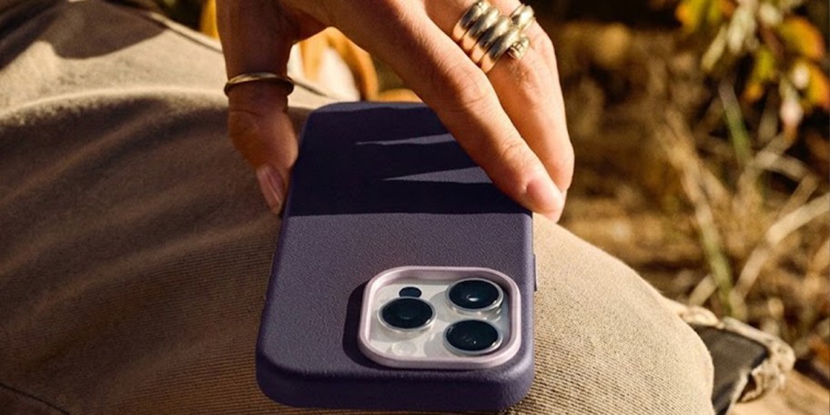 hand reaching for blue iphone in case