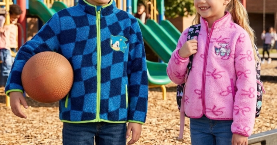 boy and girl in fleece jackets in a playground