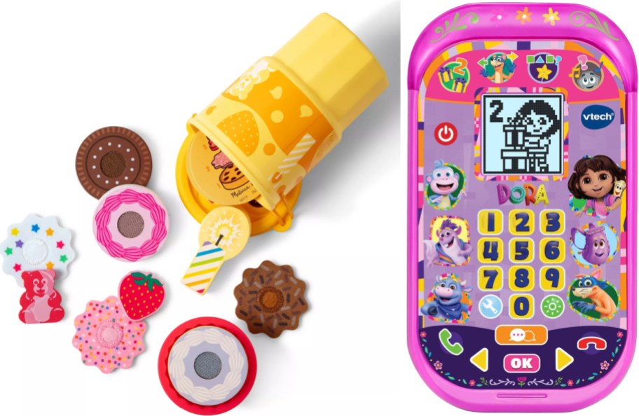 Two children's toys displayed side by side, featuring a Melissa & Doug wooden slice-and-bake cookie set with assorted cookies and a container on the left and a VTech Dora the Explorer pink toy smartphone on the right.