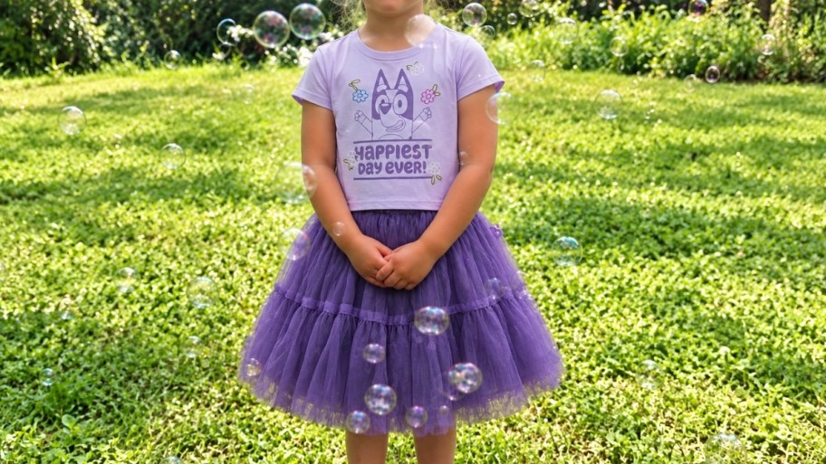 little girl wearing a purple tee and tutu set