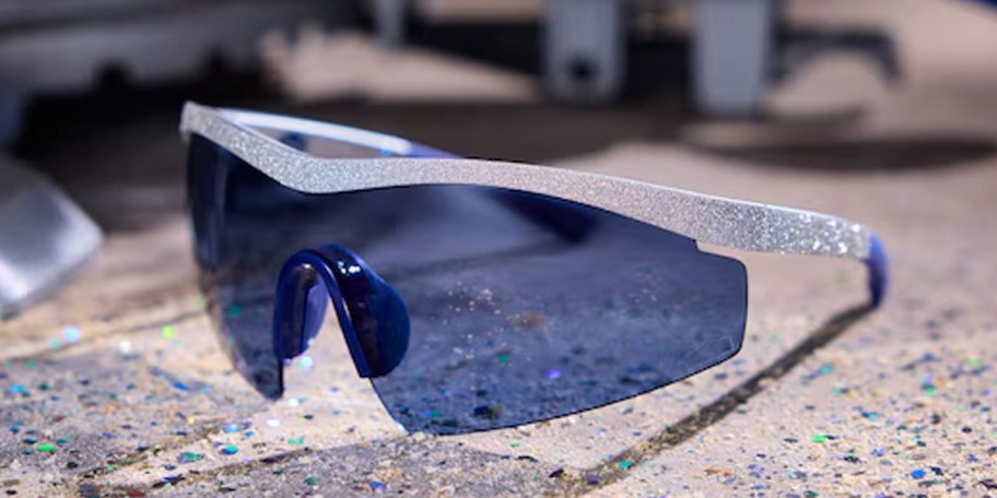 blue and silver glasses laying on table