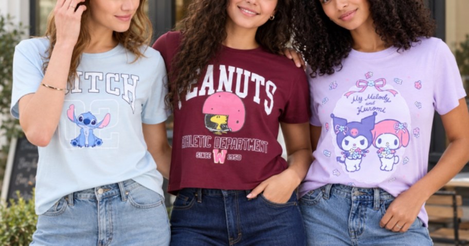3 young women wearing character graphic tees