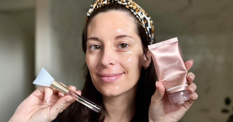 woman holding up medicube Collagen Wrapping Mask and applicator