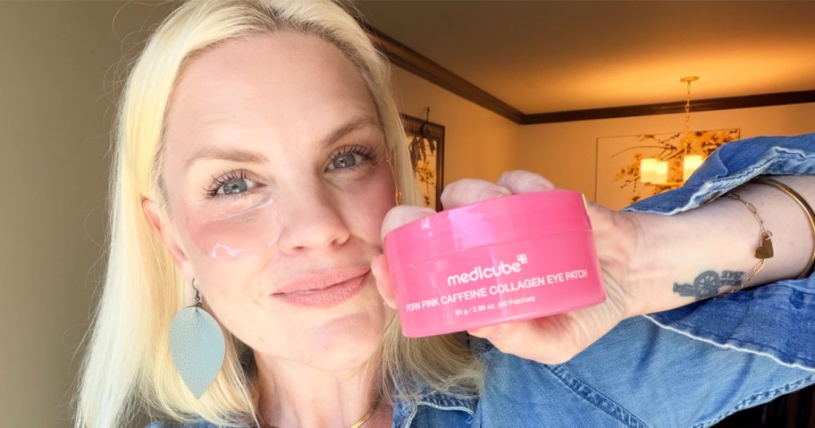 woman holding up a pink jar of medicube Hydrogel Eye Patches