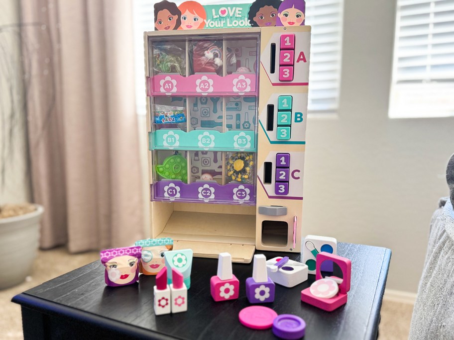 wooden beauty kiosk toy with accessories on table